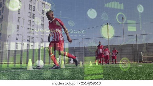 Image of interface processing data over biracial male footballer training on pitch with team. Sport, fitness, technology and digital interface concept digitally generated image. - Powered by Shutterstock