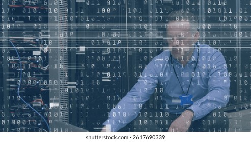 Image of interference and binary coding over caucasian man using laptop in server room. global technology, data processing and digital interface concept digitally generated image.