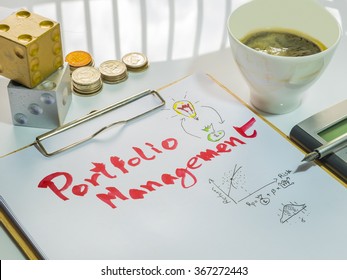 Image Of Investment Management. Portfolio Management Word On Sheet With Clipboard, Cup Of Coffee, Calculator, Pen, Coins And Dices.