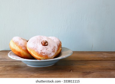 Image Of Jewish Holiday Hanukkah With Donuts On Wooden Table
