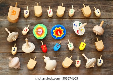 Image Of Jewish Holiday Hanukkah With Wooden Dreidels Colection (spinning Top) On The Table