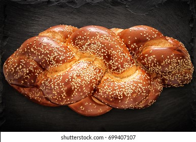 Image of jewish traditional challah bread on slate stone plate.