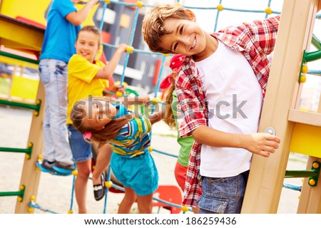 Image of joyful friends having fun on playground outdoors 