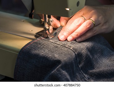 image of lady  hands sewing her cloth with the light of sewing machine, close up - Shutterstock ID 407884750