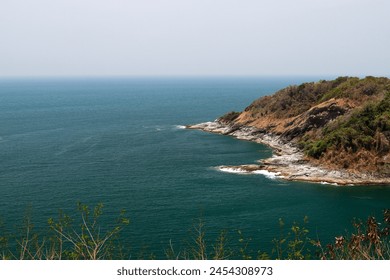 Image of a landscape in Phuket, Thailand near Promthep Cape, a beautiful seaside rock formation and blue waters. - Powered by Shutterstock