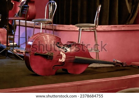 An image of a large double bass lying on the theater stage during intermission