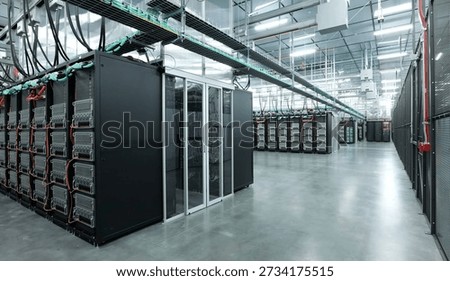 Image of a large-scale data centre, which houses numerous server racks and artificial intelligence infrastructure. These types of facility are used for AI research.