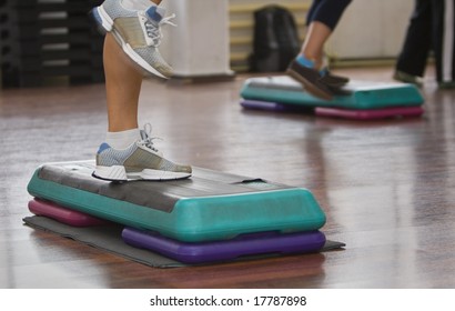 Image Of Legs Doing Step Aerobics Indoors.