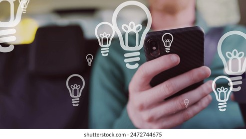 Image of light bulb icons and data processing over african american albino man using smartphone. Global business, computing, data processing and connections concept digitally generated image. - Powered by Shutterstock