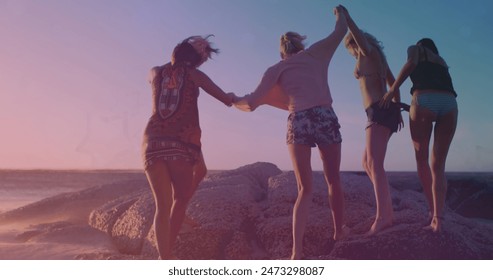 Image of light and shapes moving over diverse group of friends at beach. Light, free time and digital interface concept digitally generated image. - Powered by Shutterstock