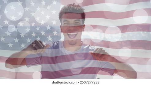 Image of light spots and american flag over happy biracial man dancing on sunny beach. America, summer, vacations, healthy lifestyle, celebration and patriotism, digitally generated image. - Powered by Shutterstock