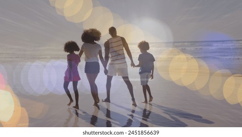 Image of light spots over african american family walking together. walk day and celebration concept digitally generated image. - Powered by Shutterstock