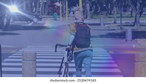 Image of light spots over albino african american man walking with bicycle. national bike to work day and celebration concept digitally generated image. - Powered by Shutterstock