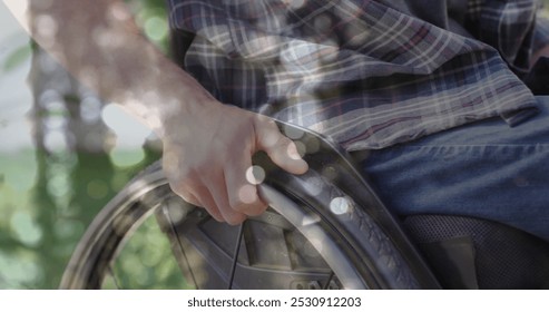 Image of light spots over disabled caucasian man sitting in wheelchair. International day of persons with disabilities concept digitally generated image. - Powered by Shutterstock