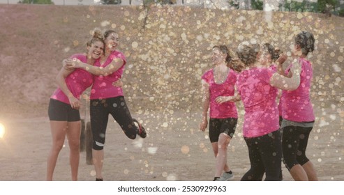 Image of light spots over diverse women at obstacle course high fiving. Global sport, health, fitness and digital interface concept digitally generated image. - Powered by Shutterstock