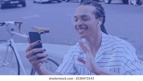 Image of light spots over happy biracial man using smartphone. national bike to work day and celebration concept digitally generated image. - Powered by Shutterstock