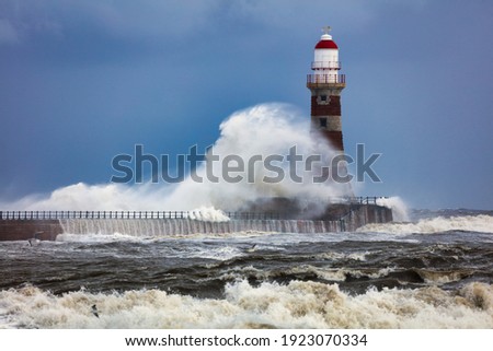 Image of a Lighthouse during a storm at Sunderland, Tyne and Wear, England, UK.