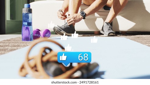 Image of like icon and numbers over african american male athlete tying shoelace. Digital composite, social media, feedback, notification, growth, technology, exercise, fitness, prepare. - Powered by Shutterstock