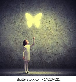 Image of little cute girl holding butterfly balloon