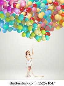 Image of little girl holding bunch of colorful balloons