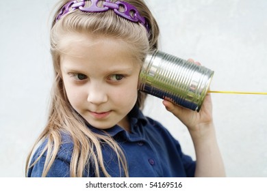 An image of a little girl with a toy-telephone