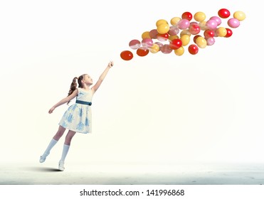 Image of little pretty girl playing with balloons