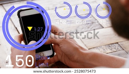 Image of loading circles with up and down arrows over caucasian man using cellphone on table. Digital composite, multiple exposure, progress, growth, digits, abstract and technology concept.