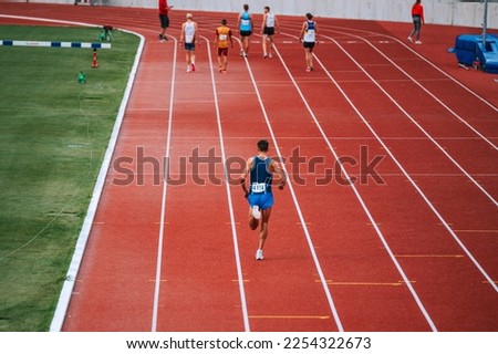 Image of long distance runners at the starting line of a 5000m race, promoting the benefits of training and exercise