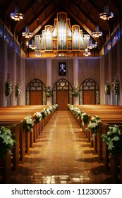 An Image Looking Back Down An Isle Of A Church On A Wedding Day