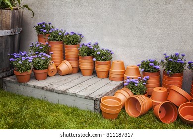 Image of lots of terracotta plant pots, at a garden center.  - Powered by Shutterstock