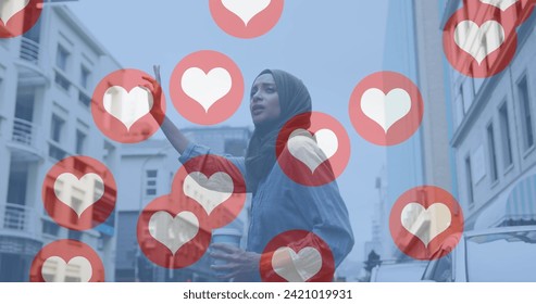 Image of love heart icons with woman in hijab hailing taxi in city street. communication technology digital interface concept, digitally generated image. - Powered by Shutterstock