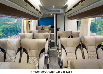 Image Of Luxury Bus Interior With Rows Of Comfortable Seats With Toilet Inside