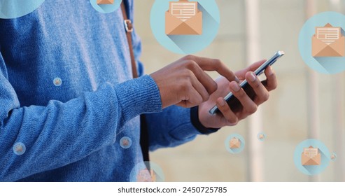 Image of mail icons over midsection of biracial man using smartphone. global connections, social media, technology and digital interface concept digitally generated image. - Powered by Shutterstock