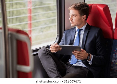 Image Of Male Commuter In Suit Traveling By Train