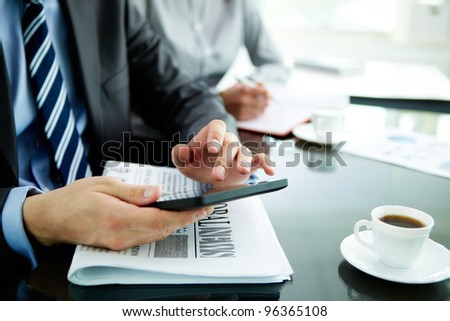 Image of male hand with digital tablet touching its screen