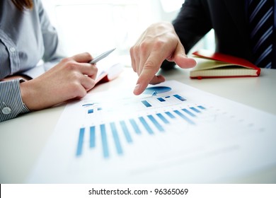 Image male hand pointing at business document during discussion at meeting