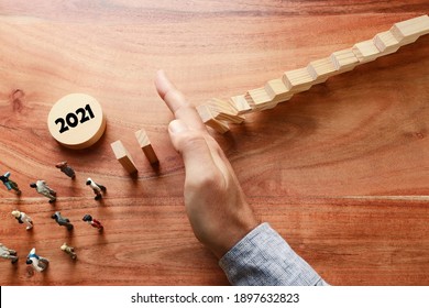 image of male hand stopping the domino effect. executive and risk control concept. 2021 new normal concept