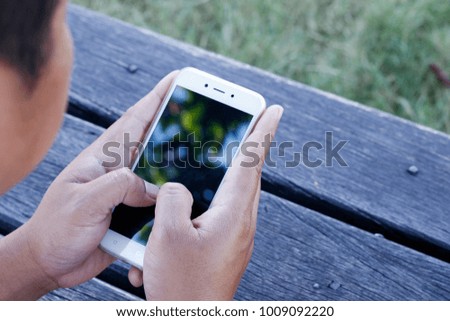 Image of male hands using smartphone.