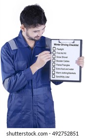 Image Of A Male Mechanic Wearing Blue Uniform And Showing Winter Driving Tips In The Studio, Isolated On White Background