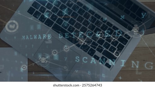 Image of malware detected text with network and data processing over laptop on desk. Connection, data, security, processing, digital interface and communication, digitally generated image.