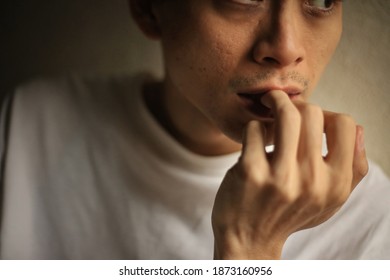 Image of a man biting his nails