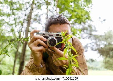Image of man with camera in woods