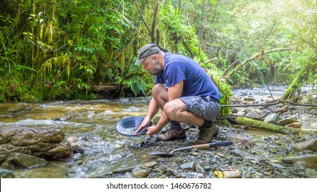 An Image Of A Man Doing Gold Panning In New Zealand