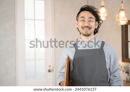 Image of a manager, owner or proprietor of a stylish cafe or restaurant Looking at the camera	