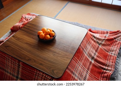 Image of mandarin oranges in a basket and kotatsu - Shutterstock ID 2253978267
