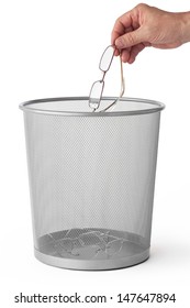 Image of man's hand throwing glasses in the dustbin, isolated on white. Conceptual photo for unnecessary glasses.