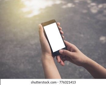 Image of man's hands are holding and using a black cell phone with white blank screen that you can put any idea and concept in this space. - Shutterstock ID 776321413