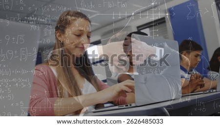 Image of math formulas moving over caucasian girl using laptop at school. learning, school, education and technology concept digitally generated image.