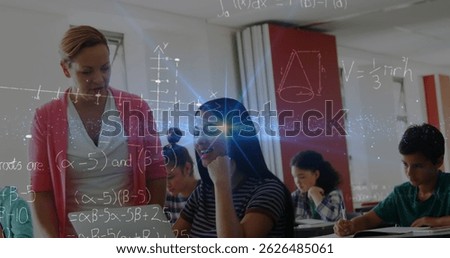 Image of math formulas moving over caucasisan female teacher helping biracial girl at school. learning, school, education and technology concept digitally generated image.