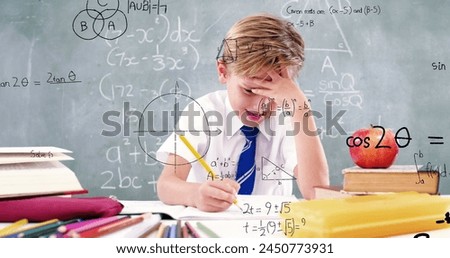 Image of math formulas over focused caucasian boy doing homework. learning, education and school concept digitally generated image.